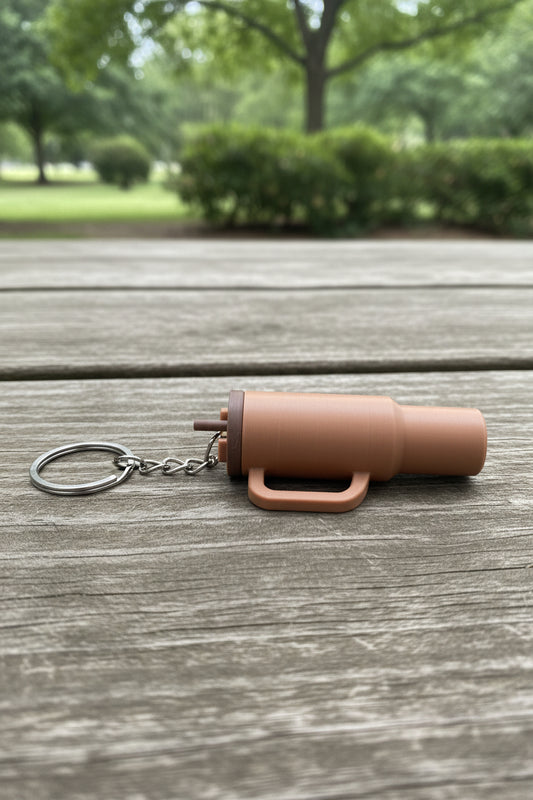 Brown cup keychain on a table in a park